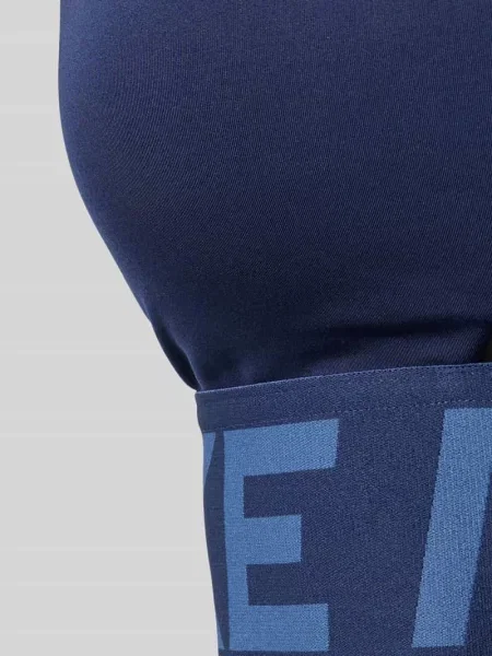 Stanik z detale z logo i wycięcie Nike Training granatowy