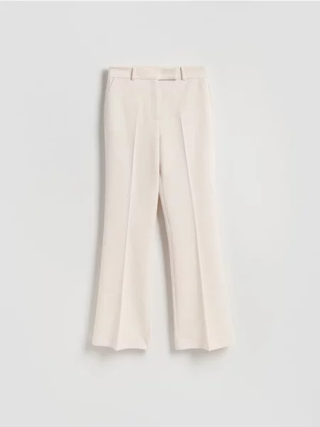 Reserved Flare nohavice so zažehlenými pukmi krémová