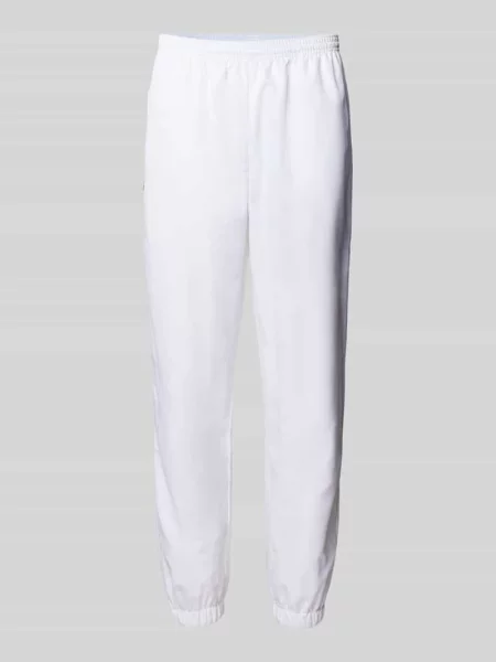 Spodnie dresowe o kroju relaxed fit z naszywką z logo Lacoste białe