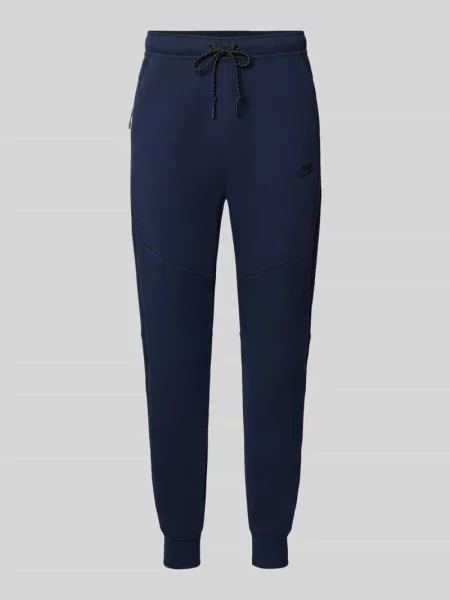 Spodnie dresowe o kroju slim fit z mieszanki bawełny Nike granatowe