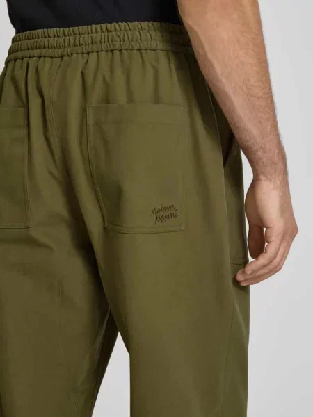 Spodnie materiałowe o kroju straight fit z bawełny Maison Kitsune