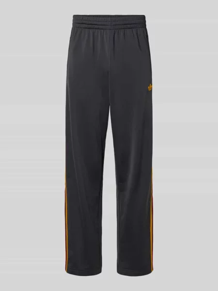 Spodnie dresowe o kroju relaxed fit z paskami z logo model FIREBIRD' Adidas Originals