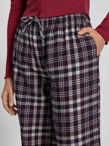 Spodnie materiałowe w kroju relaxed fit z tunelem Review granatowe