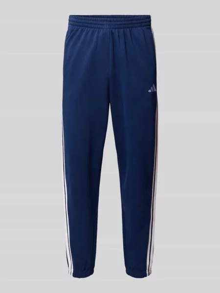 Spodnie dresowe z paskami w kontrastowym kolorze Adidas Sportswear granatowe