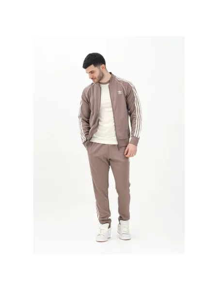 Adidas Originals spodnie dresowe SST TP beżowy z aplikacją brązowe