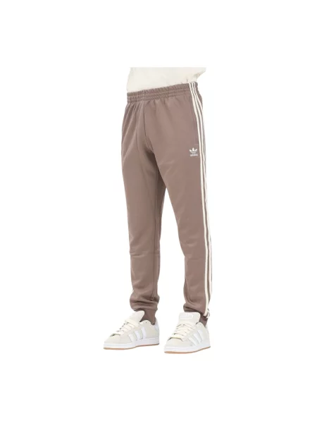 Adidas Originals spodnie dresowe SST TP beżowy z aplikacją brązowe