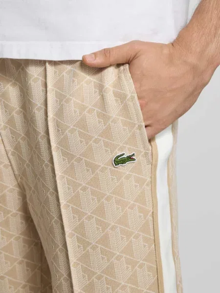 Spodnie dresowe o kroju regular fit z dodatkiem bawełny Lacoste biały