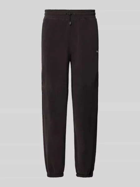 Spodnie dresowe o kroju relaxed fit z nadruk z logo model PUMATECH' Puma Performance czarne