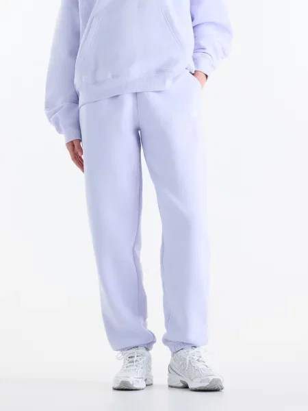 Спортивні штани New Balance Sport Essentials Fleece бавовна/поліестер фіолетовий