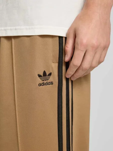 Spodnie treningowe ze szwami podłużnymi i elastycznym pasem Adidas Originals beżowy