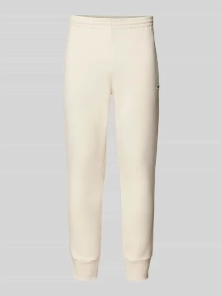 Spodnie dresowe o kroju slim fit z naszywką z logo Lacoste biały
