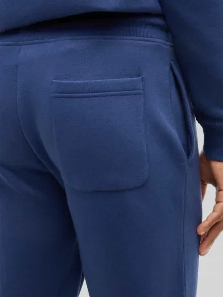 Spodnie dresowe o kroju slim fit z mieszanki bawełny Tommy Jeans granatowe