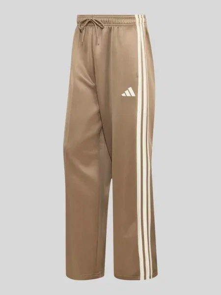 Spodnie dresowe o kroju loose fit z dodatkiem bawełny Adidas Sportswear beżowe