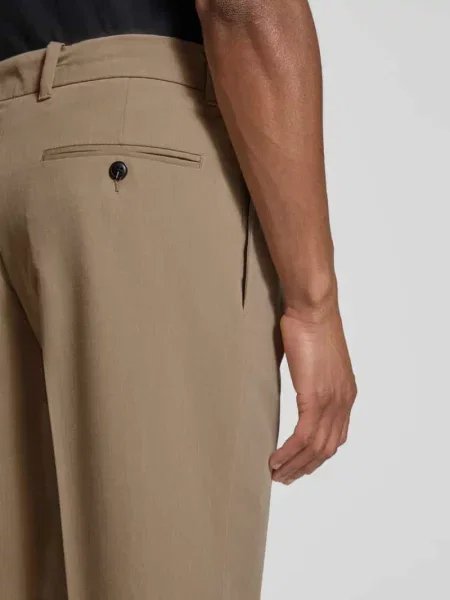 Spodnie materiałowe o kroju loose fit z zakładkami w pasie model KARL' Jack & Jones Premium beżowe
