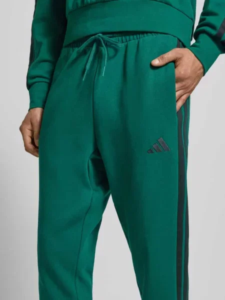 Spodnie dresowe z elastycznym pasem Adidas Sportswear zielony