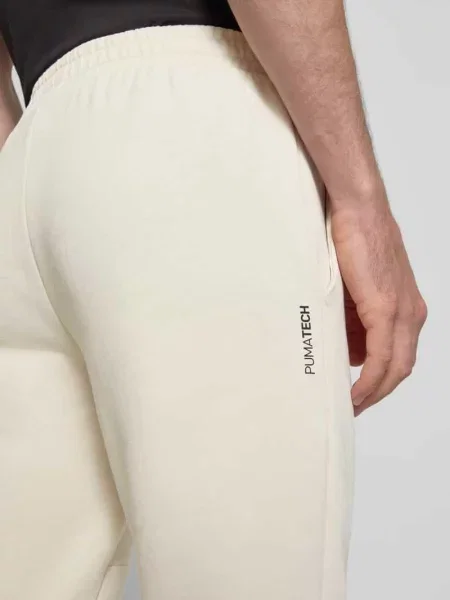 Spodnie dresowe o kroju regular fit z nadrukiem z logo model „Pumatech” Puma Performance