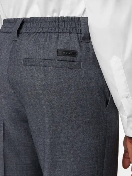 Pantaloni Versace de lână în carouri gri