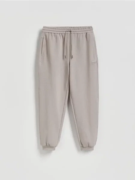 Reserved Spodnie dresowe comfort fit beżowy
