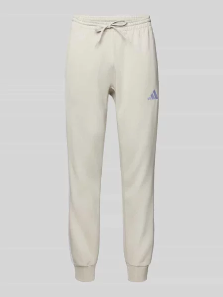 Spodnie dresowe z elastycznym ściągaczem Adidas Sportswear beżowe