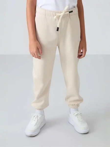Tommy Life Kalhoty TOMMY Kinder Jogginghose krémová