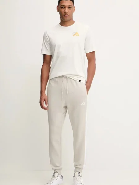 Спортивні штани adidas Essentials з аплікацією бежевий