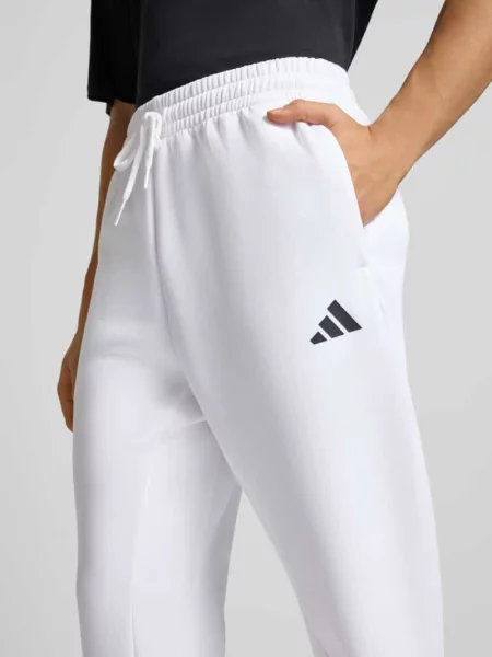 Spodnie dresowe z logo i elastycznym pasem Adidas Sportswear biały