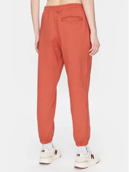 Teplákové kalhoty New Balance oranžové