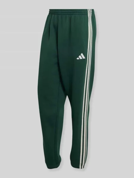 Spodnie dresowe o kroju relaxed fit z paski w kontrastowym kolorze Adidas Sportswear zielone