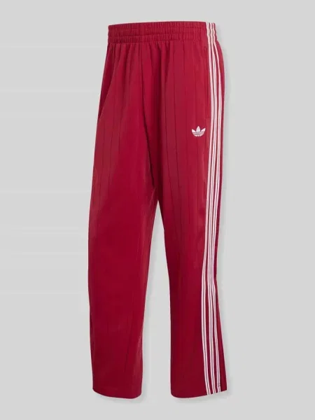 Spodnie dresowe o kroju regular fit z paskami w kontrastowym kolorze model FIREBIRD TP DN' Adidas Originals
