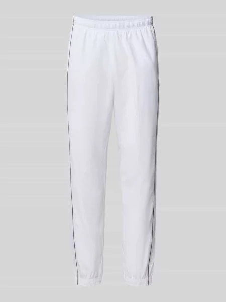 Spodnie dresowe w kroju regular fit z naszywką z logo Lacoste Sport białe