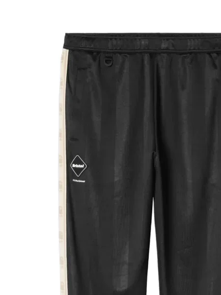 Prugaste trčanje hlače Carhartt Wip s autogramom crna