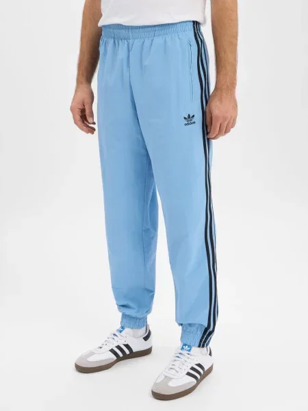 Spodnie dresowe o kroju regular fit z wyhaftowanym logo model ‘FIREBIRD’ Adidas Originals niebieski