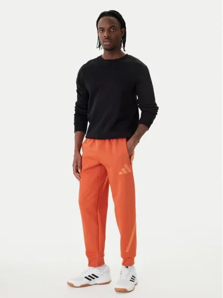 Teplákové kalhoty adidas oranžové