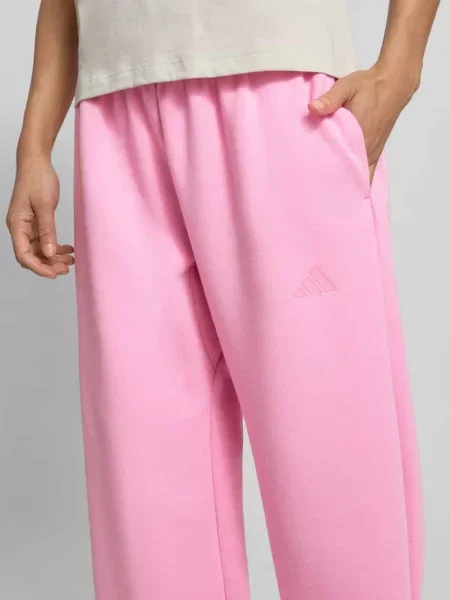 Spodnie dresowe krój loose fit z dodatkiem bawełny Adidas Sportswear różowe
