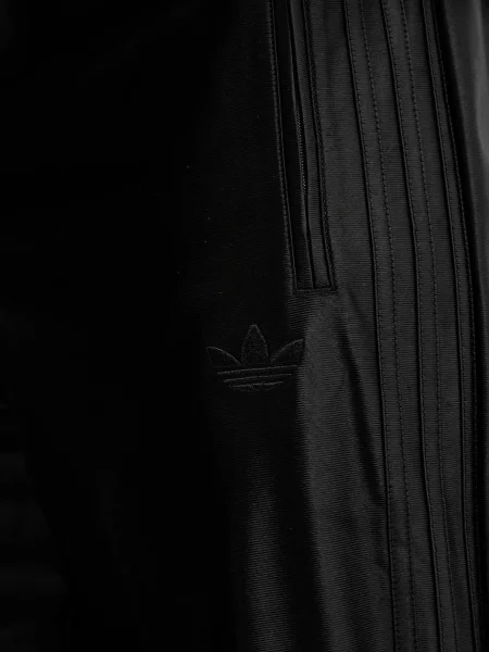 Спортивні штани adidas Originals Firebird однотонні чорний