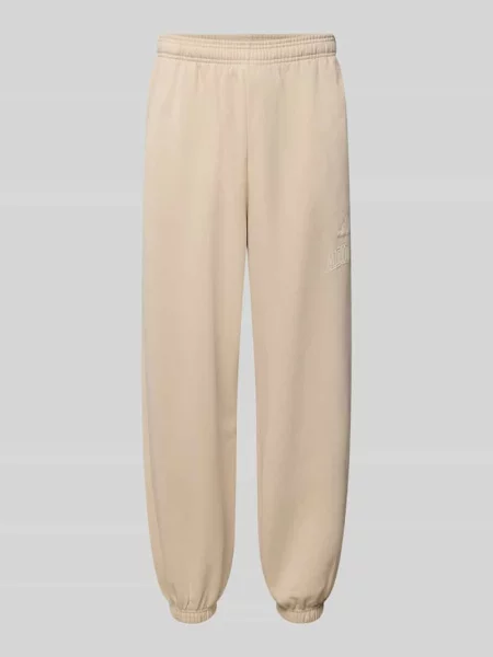 Spodnie dresowe z wyhaftowanym logo Adidas Sportswear beżowe