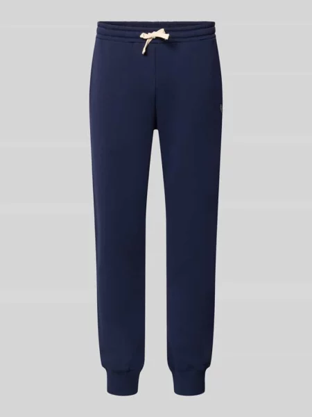 Spodnie dresowe o kroju slim fit z mieszanki bawełny Review granatowe