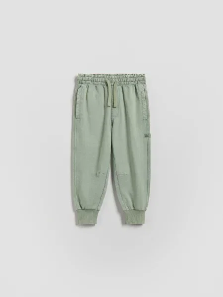 Reserved kalhoty joggers bledá zelená