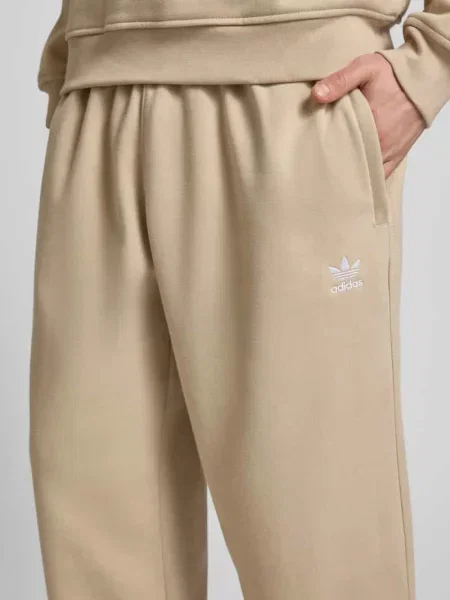 Spodnie dresowe o kroju wide fit z elastycznym pasem Adidas Originals beżowy