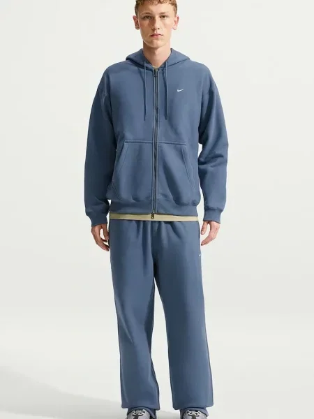 Nike Sportswear spodnie dresowe z bawełną Solo Swoosh niebieskie