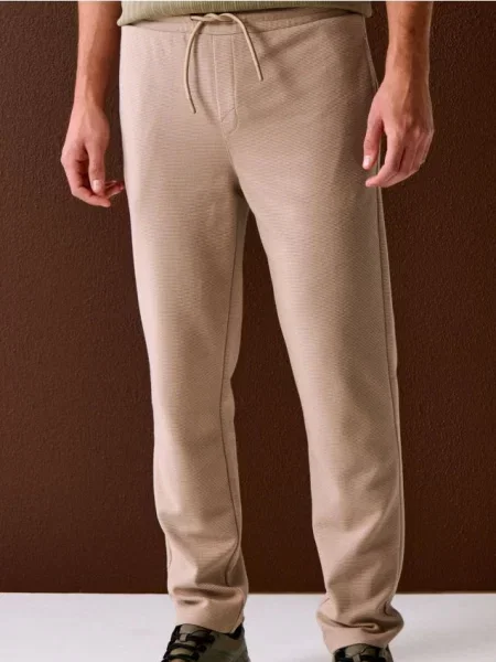 Sinsay Spodnie dresowe jogger ottoman beżowy