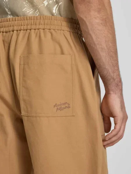 Spodnie materiałowe o kroju straight fit z bawełny Maison Kitsune beżowe