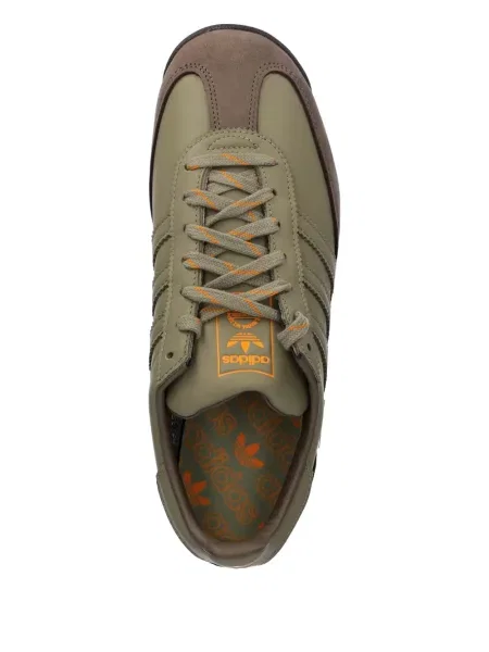 Pruhované kalhoty Adidas s výšivkou na platformě černé