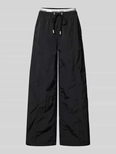 Spodnie typu track pants o kroju regular fit z paskami w kontrastowym kolorze Tommy Jeans biały