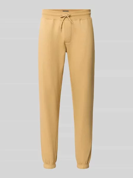 Spodnie dresowe o kroju slim fit z mieszanki bawełny Tommy Jeans beżowe