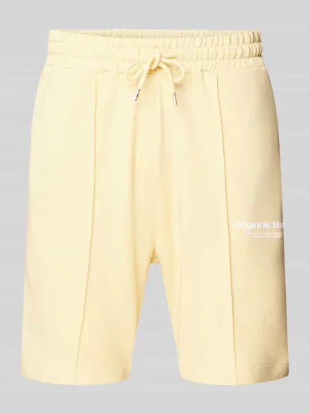 Szorty z dzianiny dresowej z tunelem model ‘ESTERBRO’ Jack & Jones żółte