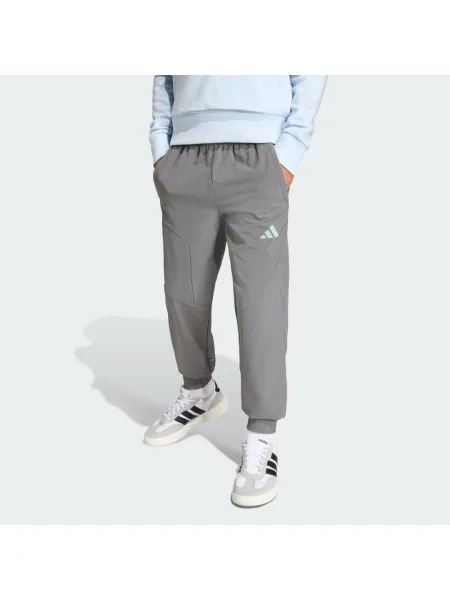 KALHOTY ADIDAS BOYS HOODED TECH WOVEN šedé