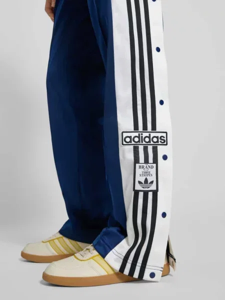 Spodnie typu track pants o kroju straight fit z lampasami model ‘Break’ Adidas Originals granatowe