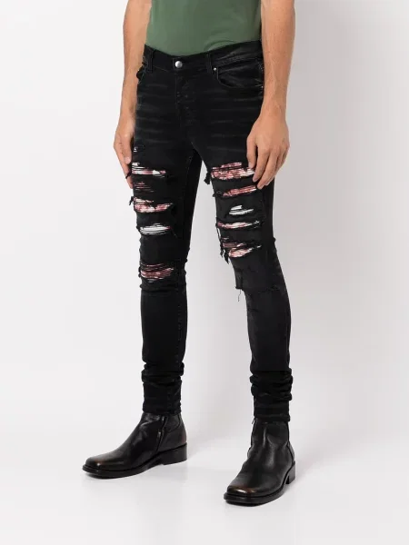 Skinny jeansy skinny Amiri z dziurami czarne
