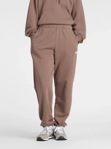 Штани спортивні New Balance SPORT ESSENTIALS FRENCH TERRY бавовна/перероблений коричневий